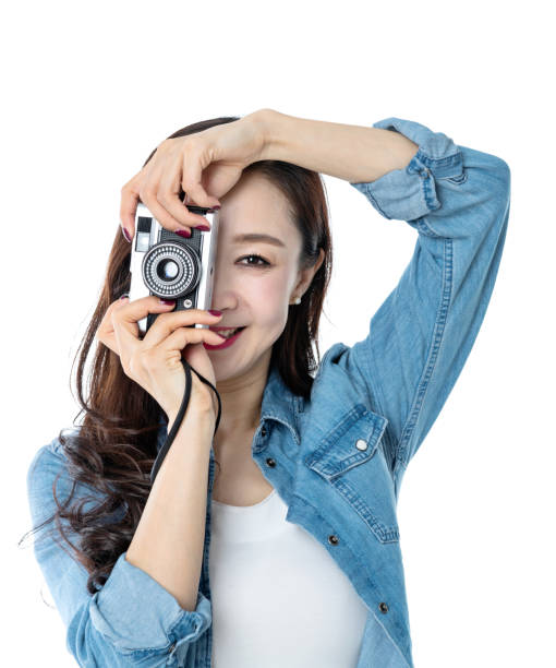 istock Beautiful woman holding an old camera on white background 1193629279
