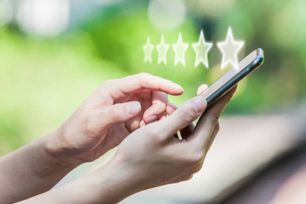 istock Customer Service Experience Performance Analysis. Close-up of Woman's Hand Holding a Smart Phone with Icon Five Star Symbol to Increase Rating of Company 1193629954