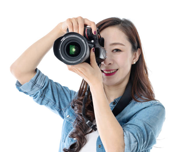 istock Woman holding professional digital camera on white background 1193630166