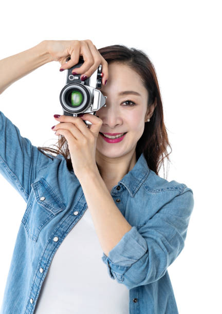 istock Beautiful woman holding a SLR camera on white background 1193630341