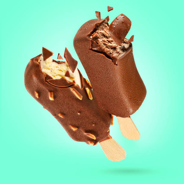 istock Two bitten chocolate ice creams popsicle on green background 1193634104
