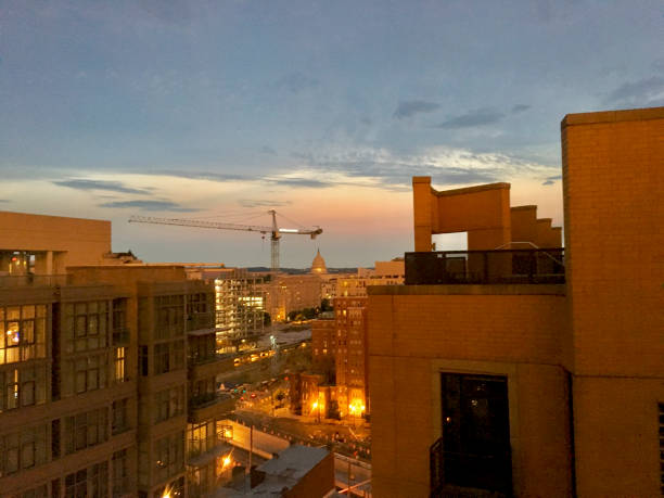 istock Sunset and construction cranes in the city 1193634255