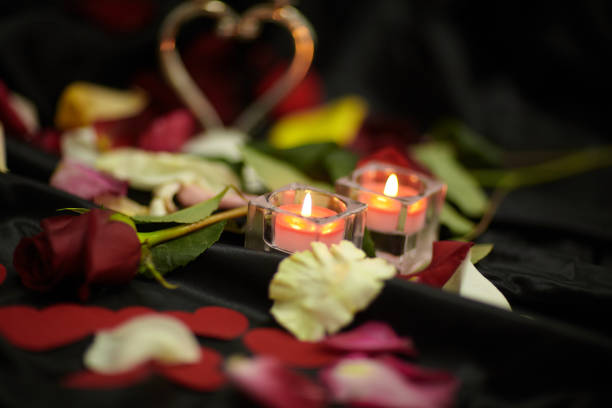istock two candles on the dark festive table 1193635922