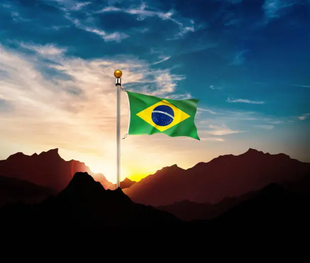 Waving Brazil flag on the mountain in sun light