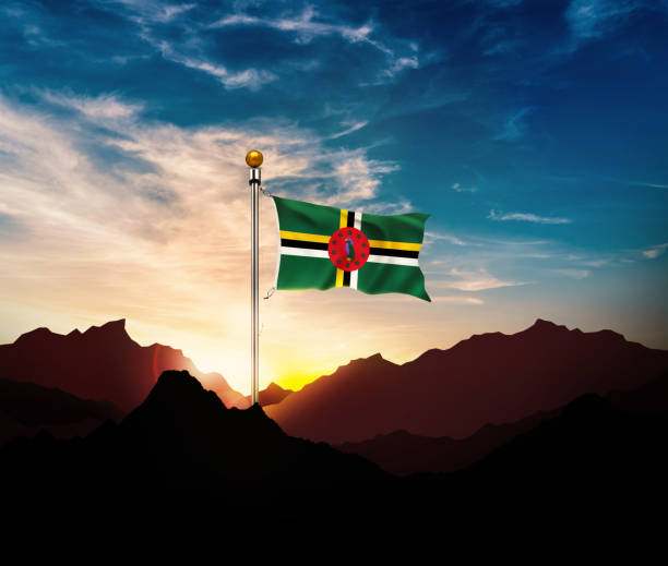 Waving Dominica flag on the mountain in sun light