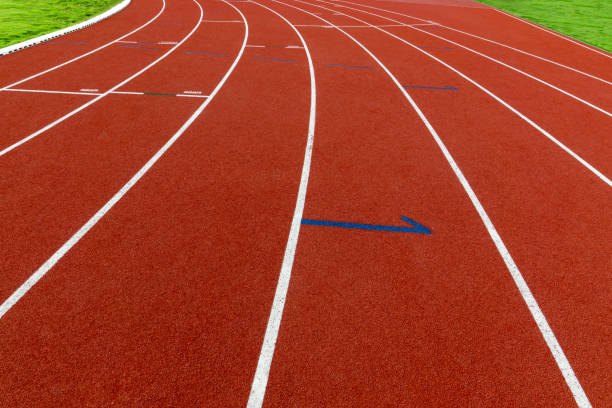 istock Curve red treadmill at the stadium and white line 1193643150