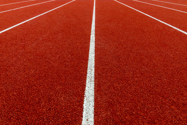 istock Red treadmill with white line at the stadium. 1193643202