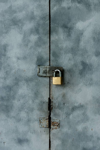 istock Old keys on painted wooden doors. 1193643324