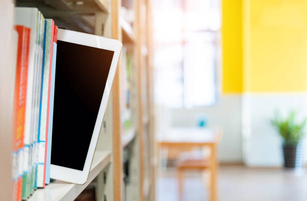 istock Library bookshelf with books and a digital tablet 1193645140