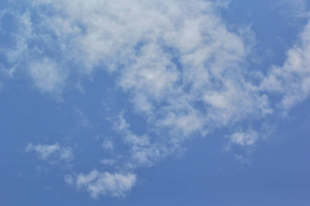 istock Beautiful blue sky with white fluffy clouds on a clear sunny day 1193645692