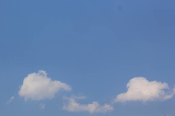 istock Beautiful blue sky with white fluffy clouds on a clear sunny day 1193645761