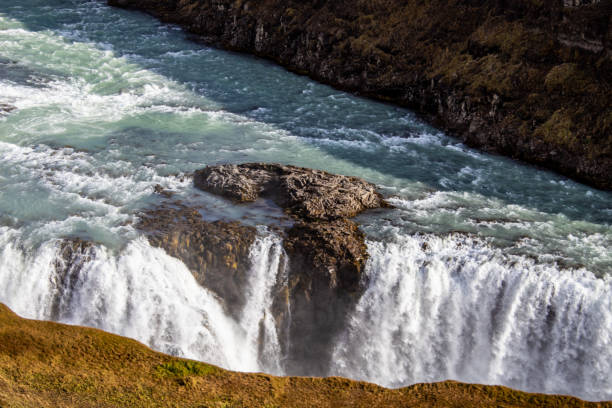 istock waterfall in Iceland with rainbow 1193646805