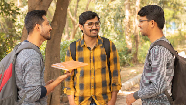 istock College friends socializing - Students talking with each other at university campus - Concept of happy college days and student life. 1193649829