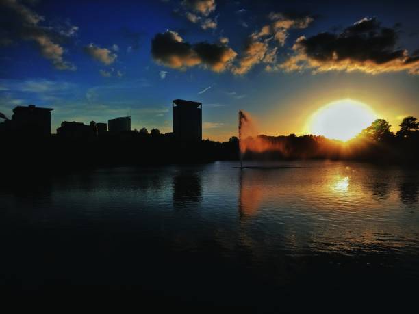 Vivid colors of the sunset along with the water fountain in Houston Hermann Park.