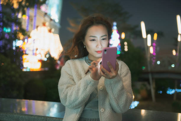 istock Asian woman using smartphone in shopping mall 1193653588
