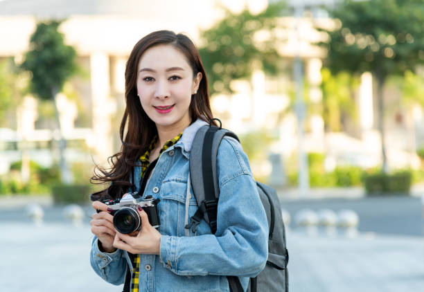 istock Women taking photos with a SLR camera 1193656831
