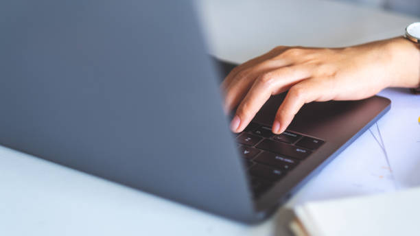 istock Businesswoman using and typing on laptop computer with paperwork 1193657818