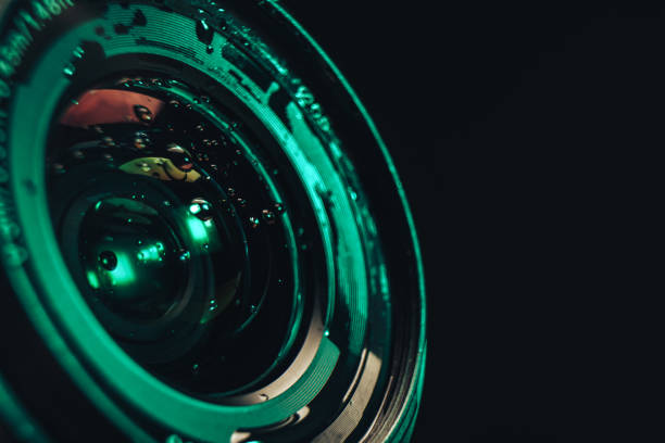 istock Close up beautiful Camera lens of drop water, aqua menthe light on a black background pattern for design. 1193661685