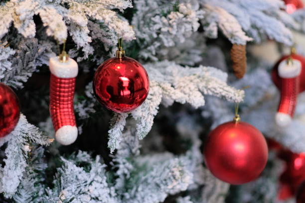 istock close up red sock and ball on christmas tree. 1193661691