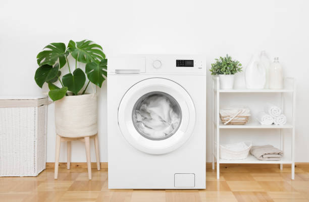 Interior of pastel colors laundry room with modern washing machine Interior of pastel colors laundry room with modern washing machine washing machine photos stock pictures, royalty-free photos & images