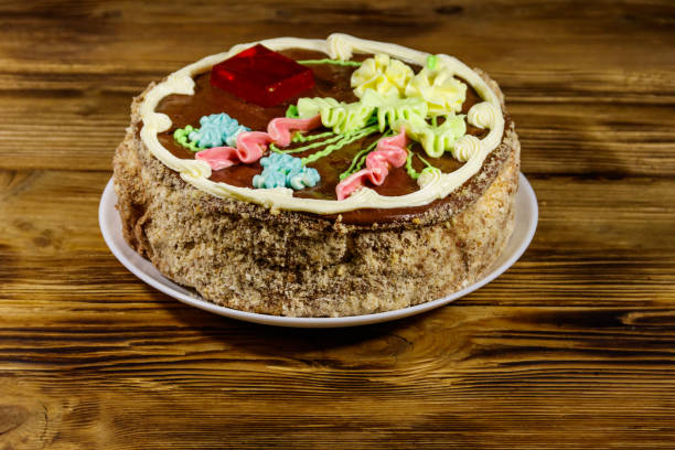 istock Kiev cake with cream, nuts and meringue on wooden table 1193666940