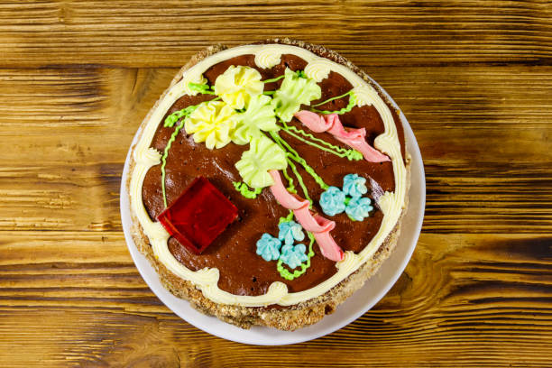 istock Kiev cake with cream, nuts and meringue on wooden table. Top view 1193666941