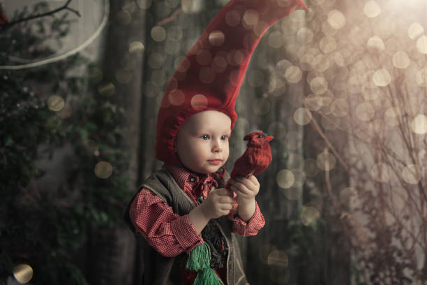 Asian girl in warm clothes holding beautiful roses with red heart on ground. Snow falling with super moon on night sky above snowy in winter. valentine's day. The moon taken with my camera.
