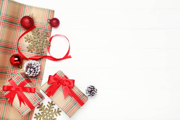 istock Gift boxes with ornaments and cones on white wooden table 1193667683