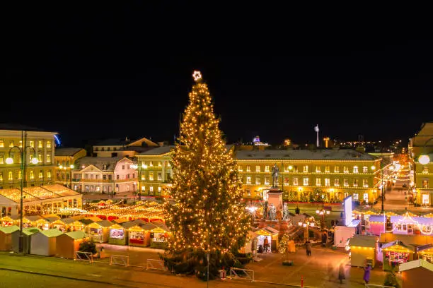 This pic shows The helsinki chrstmas market and  illuminated Senat Square with the Helsinki cathedral in winter time. The square is decorated with Christmas lights and market. The pic  is taken in december 2019.