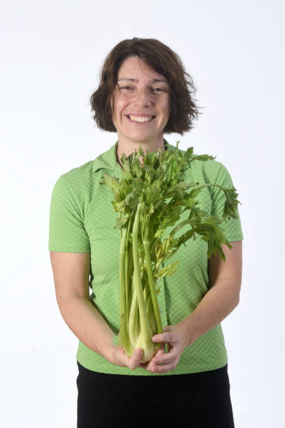 istock woman with vegetables on white background 1193669126