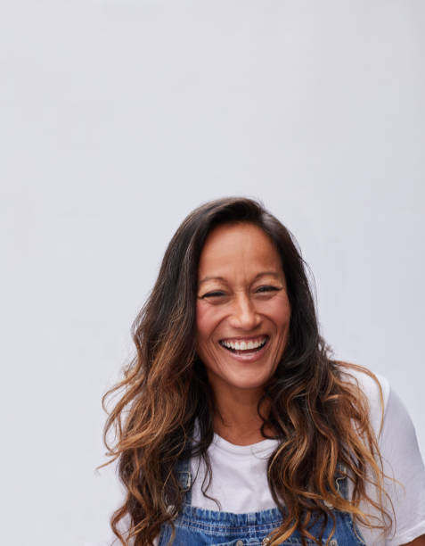 istock Mature woman laughing while standing against a gray background 1193669139