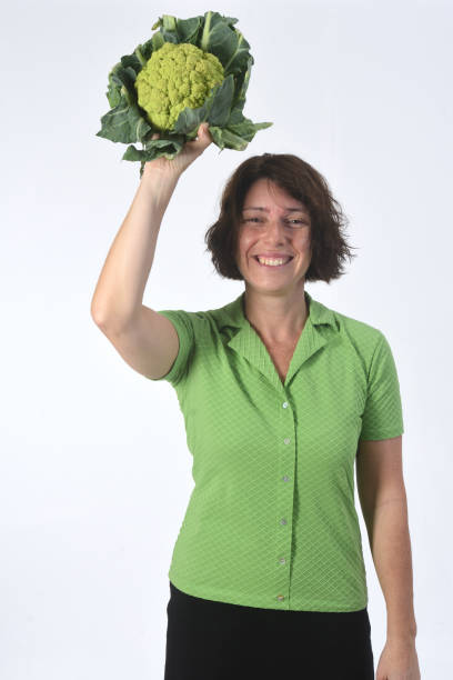 istock woman with vegetables on white background 1193669167