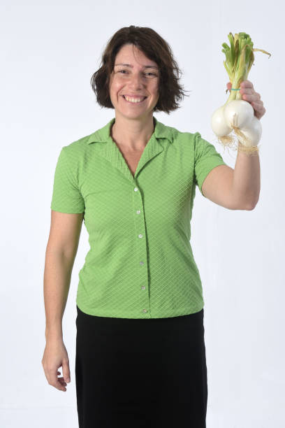 istock woman with vegetables on white background 1193669245
