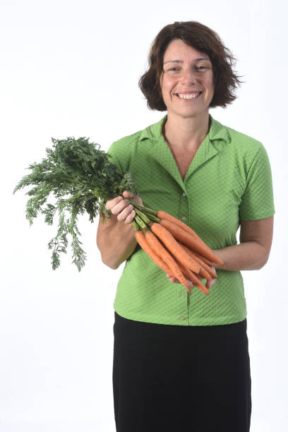 istock woman with vegetables on white background 1193669282