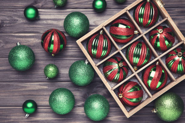 istock Christmas baubles in box on wooden table 1193670080