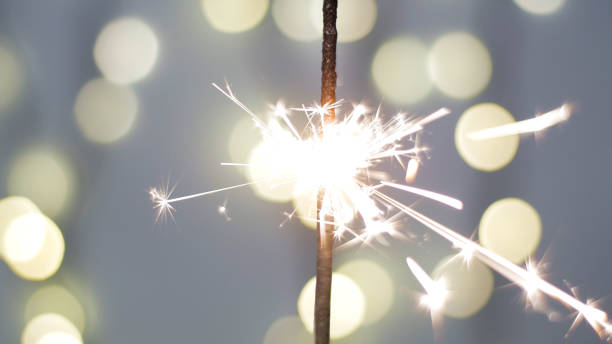 istock Close-up of firework sparkler burning. Fireworks burn on a blue background 1193670625