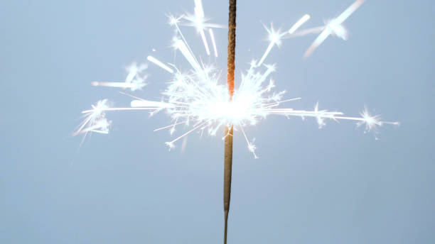 istock Close-up of firework sparkler burning. Fireworks burn on a blue background 1193670643