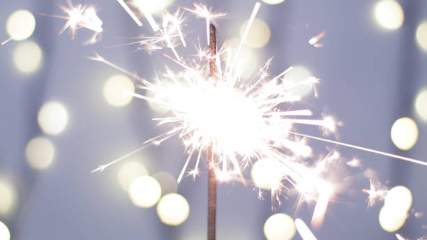 istock Close-up of firework sparkler burning. Fireworks burn on a blue background 1193670803
