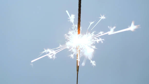 istock Close-up of firework sparkler burning. Fireworks burn on a blue background 1193670825