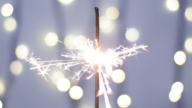 istock Close-up of firework sparkler burning. Fireworks burn on a blue background 1193670853