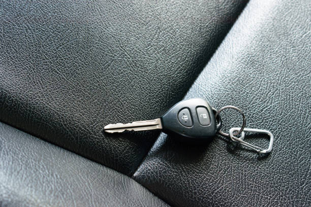 istock Car keys on the black seat. Transport concept. 1193672070