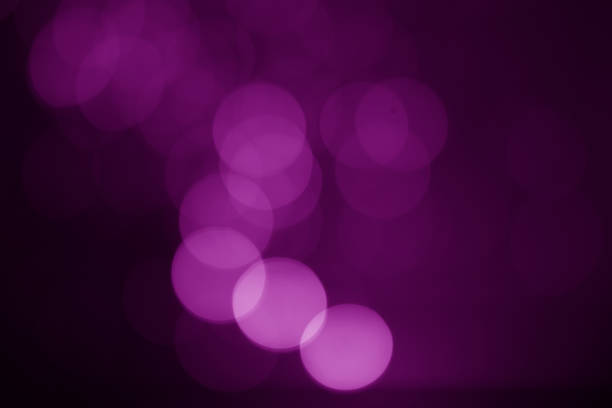 istock Abstract purple bokeh on a black background 1193672426
