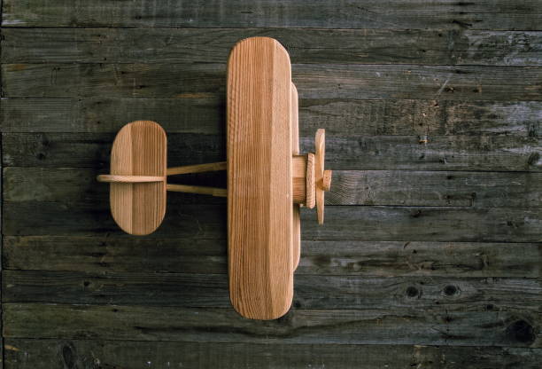 children's wooden airplane biplane stands on a rough wooden table