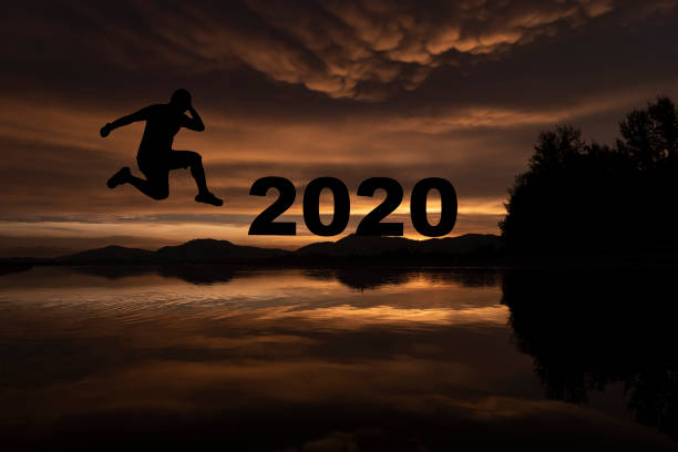istock Silhouette Young man jumping to change 2019 between the 2020 , New year concept. 1193675586