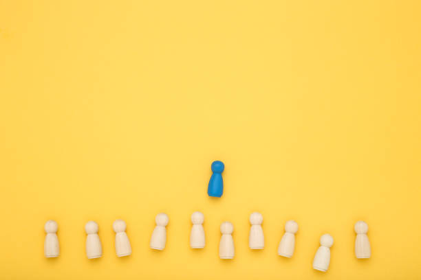 istock Leader concept. Wooden figures on yellow background 1193676898