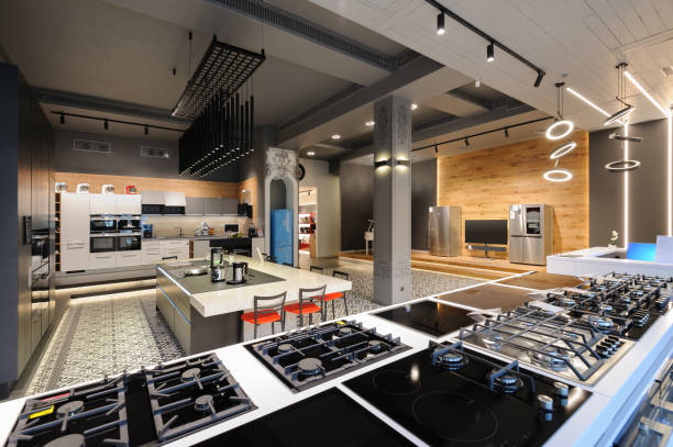 Brand new gas stoves in apliance store showroom Many gas stoves selling in appliance retail store showroom, ovens and other home appliance at background expensive grand piano stock pictures, royalty-free photos & images