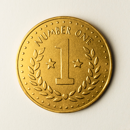 Gold number one medal coin, metal chocolate currency, for a first class gift or a prize for a winner, or a mothers day gift