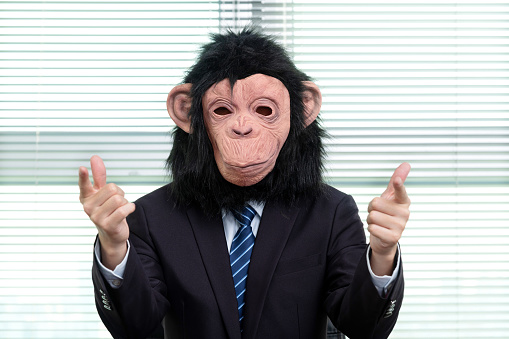 Businessman wearing a mask and pointing to the front.