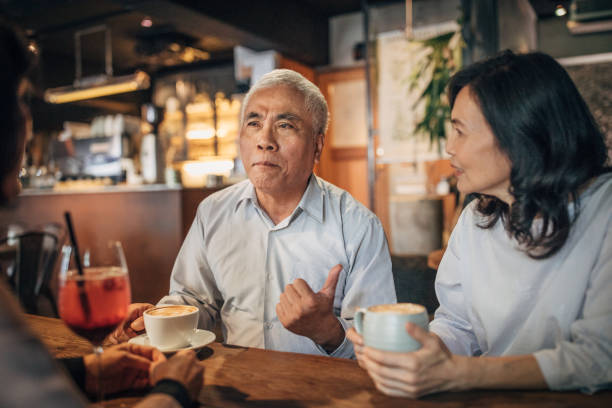 istock Senior friends sitting in cafe together 1193685487