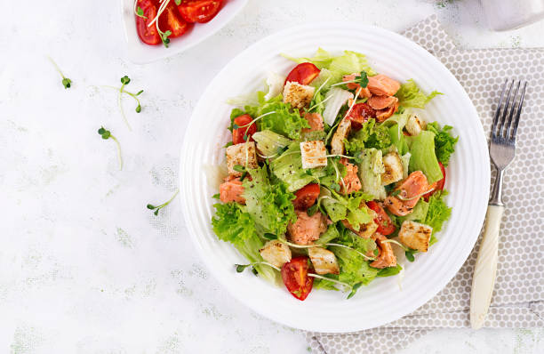 istock Caesar Salad with Salmon. Fish menu. Seafood - salmon. Top view, overhead, copy space 1193687130